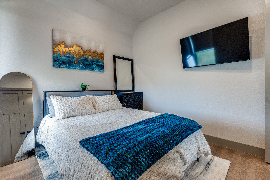 Custom ADU bedroom with modern decor and wall-mounted TV by Estate ADU in University Park, TX.