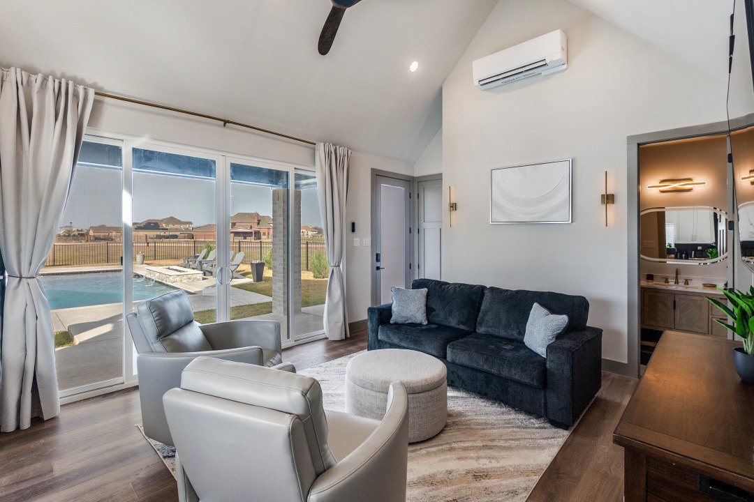 Living room with pool views in custom ADU by Estate ADU in Westover Hills, TX.