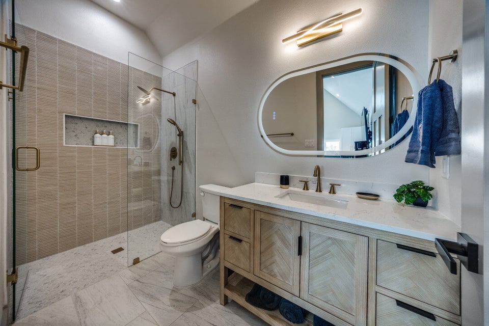 Modern bathroom with walk-in shower and double vanity by Estate ADU in Dallas, TX custom home project.