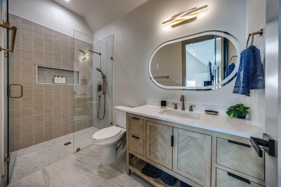 Modern bathroom with walk-in shower and double vanity by Estate ADU in Dallas, TX custom home project.