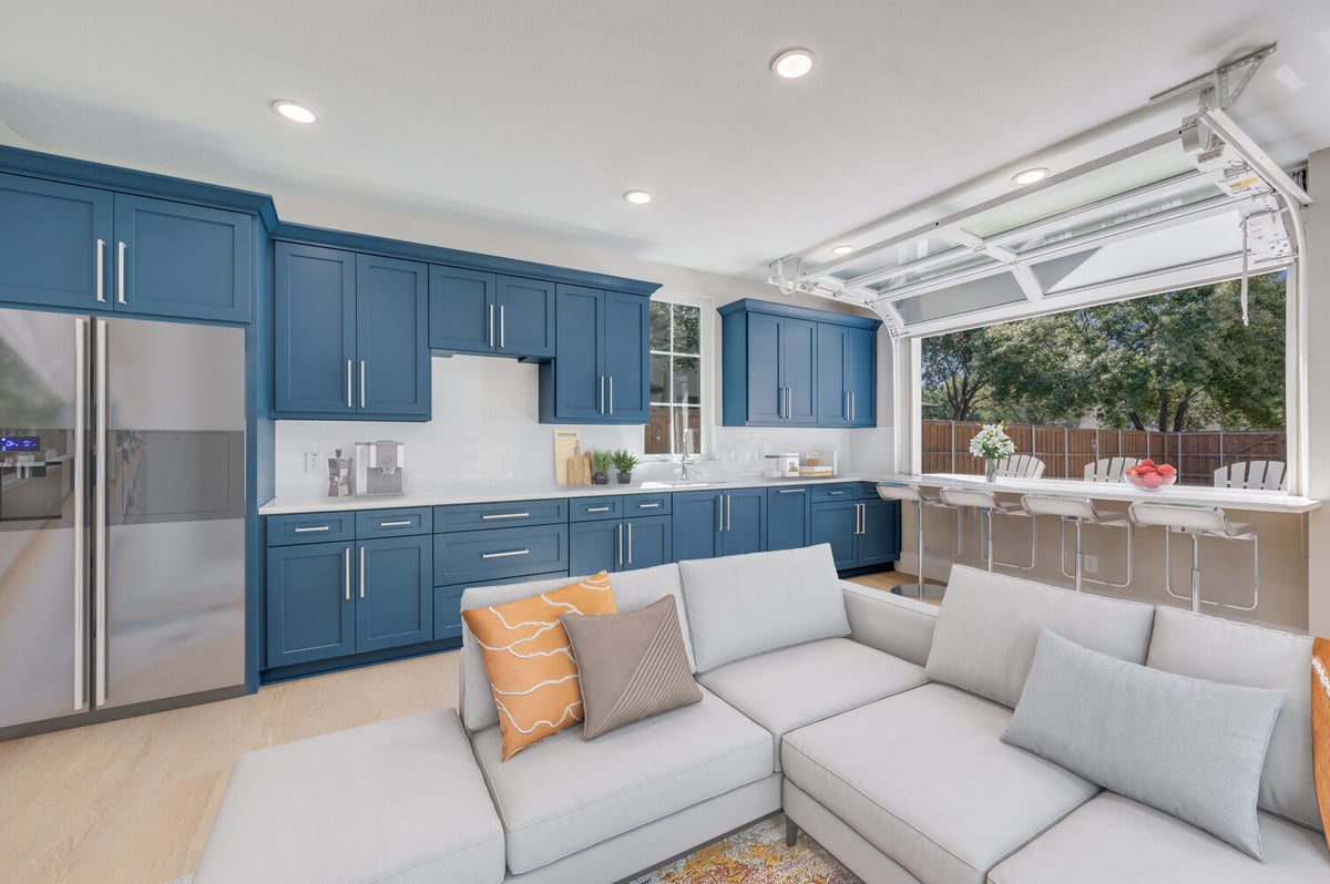 ADU kitchen view from living area in Dallas, TX by Estate ADU with large sectional and outdoor pass-through window.
