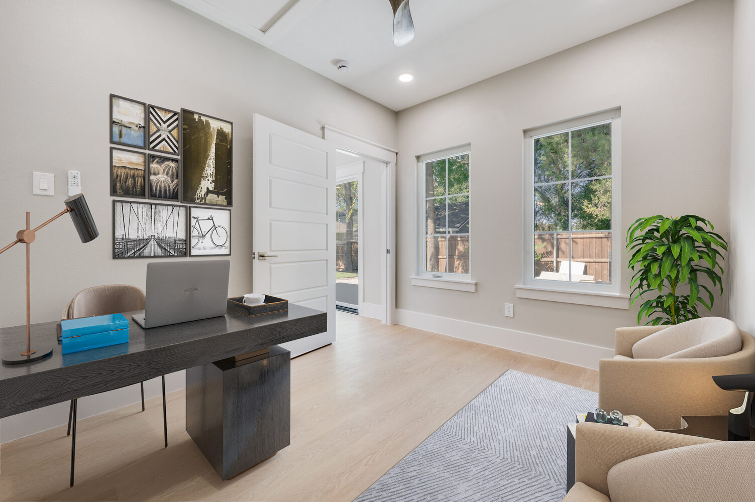 Estate ADU home office setup in Dallas, TX featuring modern furniture, art wall, and large windows.