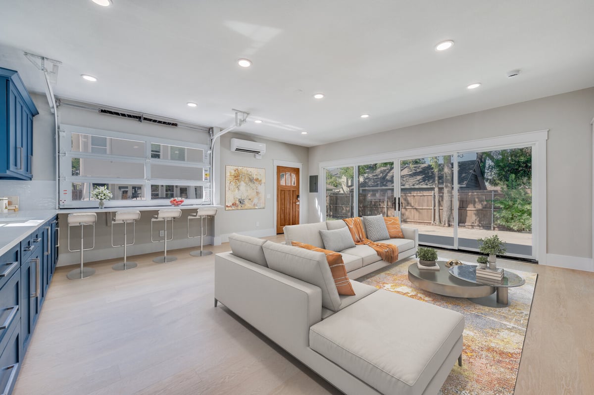 Interior living space of Dallas ADU by Estate ADU featuring large windows, bar seating, and modern furniture.