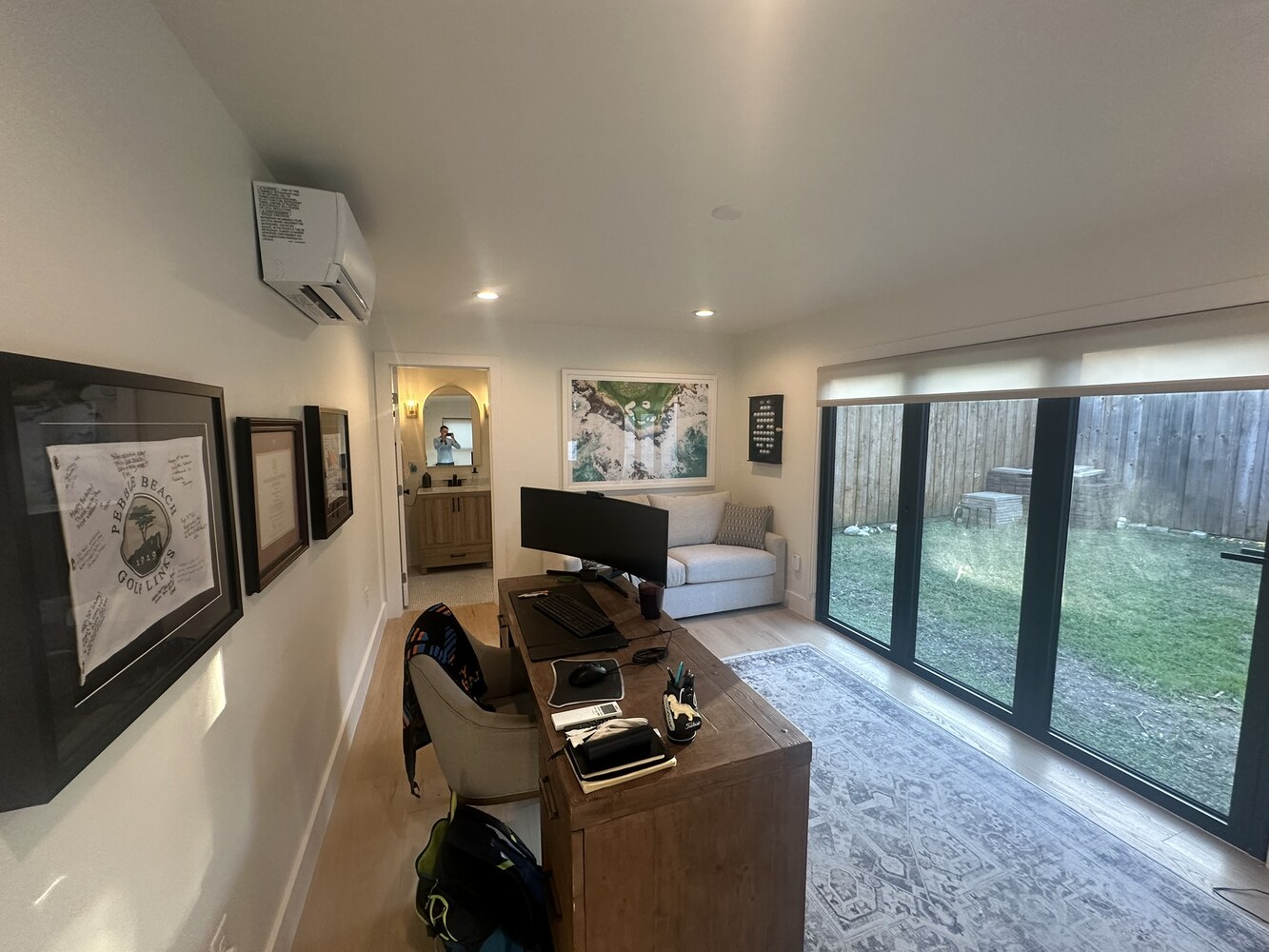 Modern office interior in Dallas ADU by Estate ADU with framed artwork and view into bathroom.