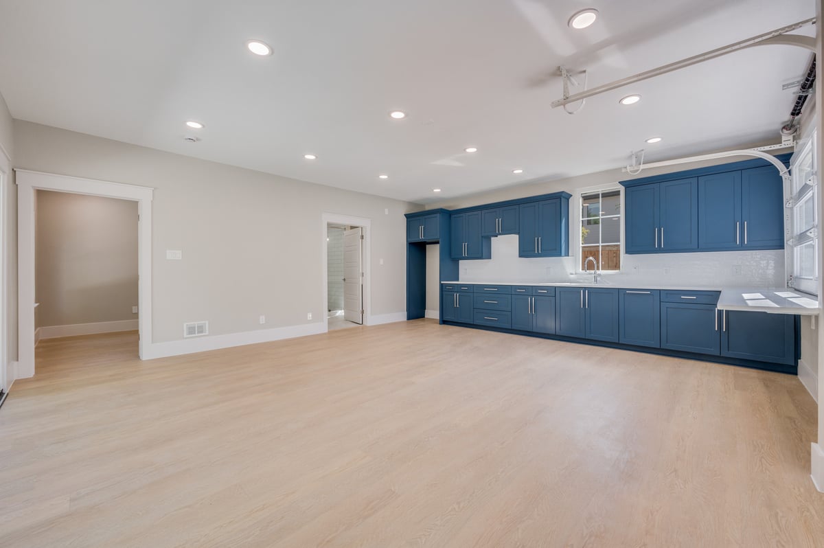 Spacious unfurnished ADU kitchen in Dallas, TX custom built by Estate ADU with bright lighting and wood floors.