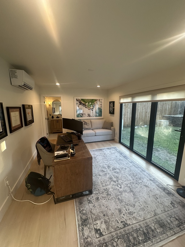 Custom home office in Dallas ADU by Estate ADU with desk workspace and large sliding doors.