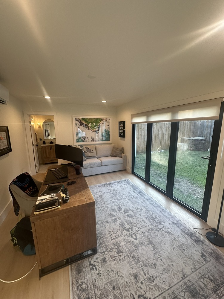 Full interior view of ADU office in Dallas, TX by Estate ADU with sliding doors and large area rug.
