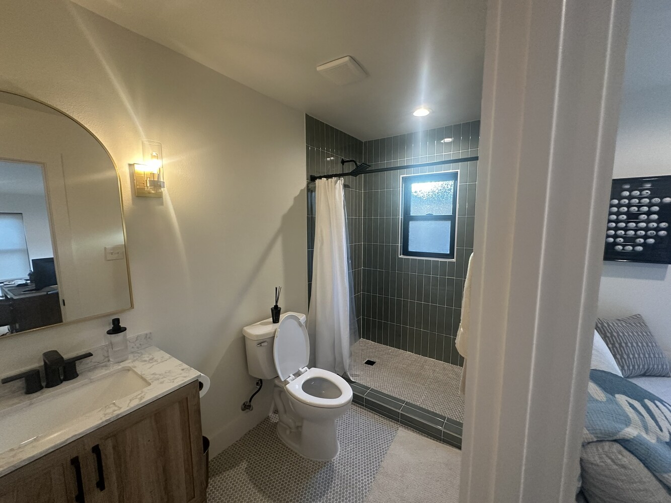 Stylish ADU bathroom interior in Dallas, TX by Estate ADU with wood vanity and glass shower view.